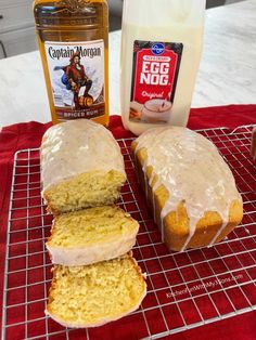 a loaf of bread sitting on top of a cooling rack next to a bottle of egg nog