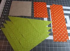 several pieces of fabric are laid out on a cutting board