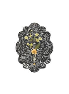 an intricately designed brooch with flowers and leaves in the center on a white background