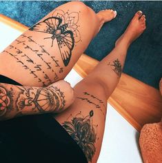 a woman's legs with tattoos on them