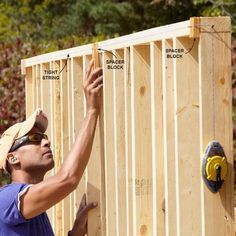 a man is working on the framing of a house