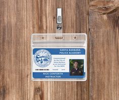 an id badge attached to a wooden wall