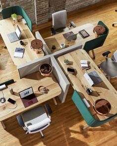 an overhead view of two tables with chairs and laptops on them in a living room