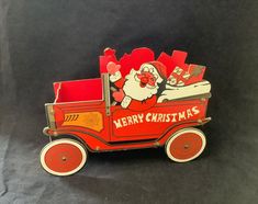 an old fashioned christmas card box with santa claus riding in it