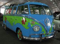 an old vw bus painted in blue and green