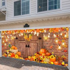 an outdoor fall scene with pumpkins and sunflowers in front of a house