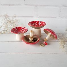 three red and white dishes sitting next to each other