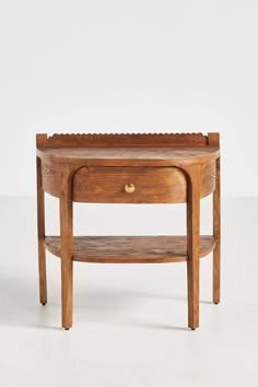 a wooden table with a shelf on the bottom and one drawer at the top, against a white background