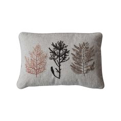 an embroidered pillow with three different types of plants on the front and back of it