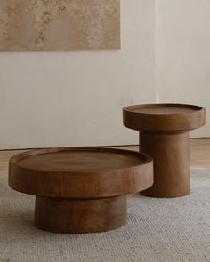 two wooden tables sitting on top of a rug