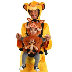 a man in a lion costume holding a baby wearing a kangaroo costume on his chest