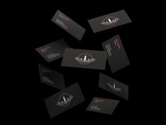 some business cards are arranged in the shape of a circle on a black background with red and white logos