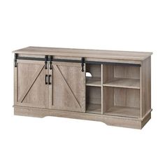 an entertainment center with sliding doors on the front and side, in light brown wood