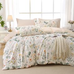 the comforter is made up with flowers on it