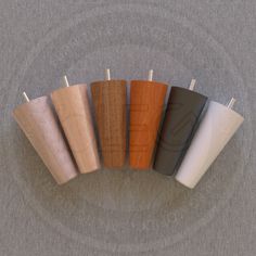 five different types of wood plugs on a gray surface with white and black wires