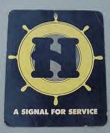 a signal for service sign on the side of a boat's hull, with an anchor and steering wheel