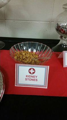 a table topped with lots of food on top of a red cloth covered tablecloth