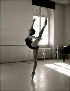 a ballerina is practicing her moves in the dance studio