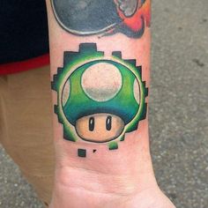 a tattoo on the arm of a person with a mushroom and other things in the background