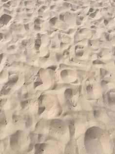 footprints in the sand on a sunny day