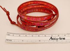 Red, red, red iridescent Tila tile beads and 1.5mm metallic red leather cord make up this multi-wrap bracelet. Length can be adjusted. It's easy to cut off excess leather and knots. Closure is beautiful domed and faceted flower-shaped red button. Knotted leather loops. Designed and created by TLP of Takeen Arts. Item B485. Red Adjustable Bohemian Wrap Bracelet, Adjustable Red Wire-wrapped Jewelry, Adjustable Wire Wrapped Red Jewelry, Adjustable Red Wire Wrapped Jewelry, Handmade Adjustable Red Wrap Bracelet, Adjustable Red Handmade Wrap Bracelet, Red Adjustable Wire Wrapped Bracelets, Red Wrap Bracelet With Round Beads, Adjustable Red Wire Wrapped Bracelets