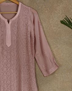 A Firgun exclusive straight Chikankari kurta in beautiful shade of Rosy Brown. The kurta features fine resham hand embroidery done on a premium georgette fabric. It has a classic chikankari jaal in the front and scattered floral butis at the back.  Product - Straight Kurta Colour - Rosy Brown Fabric - Viscose Georgette Sleeves - Full Embroidery - Bakhiya, Phanda Thread - Resham Origin - Lucknow Time to complete - 2-3 months NOTE - This product is hand embroidered and may have some inconsistencie Elegant Festive Traditional Wear With Cutwork, Unstitched Long Sleeve Cutwork Kurta, Designer Salwar Kameez With Cutwork And Straight Kurta, Designer Cutwork Kurta For Eid, Designer Wear Kurta With Cutwork For Eid, Bollywood Style Tops With Chikankari Embroidery, Long Sleeve Kurta With Cutwork For Eid, Bollywood Style Top With Chikankari Embroidery, Elegant Cutwork Kurta For Diwali