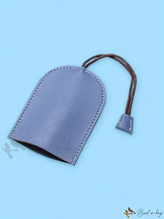 a blue leather tag with a cord attached to it on a light blue background,