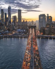 an aerial view of a bridge with lots of traffic going over it in the city