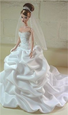 a barbie doll wearing a wedding dress and veil