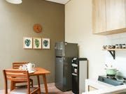 a kitchen with a table and chairs next to a refrigerator