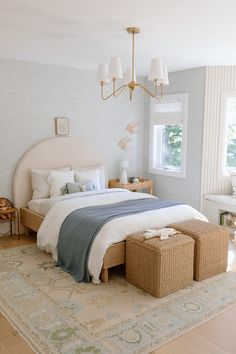 a bedroom with a large bed and two baskets on the floor