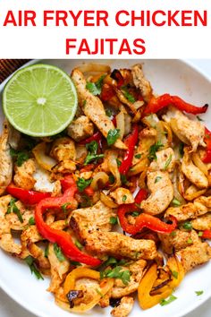 chicken fajitas on a plate with lime and cilantro