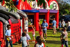 many people are playing in an inflatable park