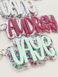 "Ready to add a little fun to your bags? Personalized acrylic keychain is a perfect addition to any backpack, diaper bag, sports bag, swim bag, lunch box, etc.!  Also perfect for bridal parties.  The options are endless. D E T A I L S: - Keychain is cut from 1/8\" quality acrylic. - Back is glitter acrylic. - Keychain will measure 3-4\".  Height will vary based on length of name. - Gold or silver lobster clasp included. P E R S O N A L I Z A T I O N: - Please include the name you would like on your keychain.  Double check your spelling as we will copy and paste what you have typed. P L E A S E NOTE: -Acrylic is plastic and if hit or dropped on a hard surface it could possibly break. We are not responsible for broken or damaged keychains/bag tags. Please handle with care. -No returns or ref Trendy Personalized White Keychains, Trendy White Personalized Keychains, Customizable Cute School Keychains, Cute Customizable School Keychains, Personalized White Keychain For School, Custom Name Pink Keychains For School, Trendy Custom Name Keychain For Gift, Trendy White Personalized Gift Keychain, Trendy Custom Name Keychain Gift