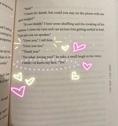 an open book with pink and white hearts on it