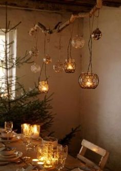 a dining room table is set with candles and place settings