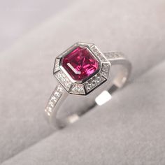 ◆ The ring is handcrafted from sterling silver and decorated with a dazzling 6*6 lab ruby. It is suitable for engagement occasion/daily wear. ◆ Production Description: Main stone Type: Lab Grown Ruby Main Stone Shape: Asscher Cut Main Stone Size: 6*6 Side stone: CZ Metal: 925 Sterling silver - Other options available in the drop down menu ◆ Customization: √Add Engraving √Other Metal Type Available √Other Gemstones & Shapes Available √Personalization Requests Available ◆ Packaging: To give yo Dainty Ruby Ring, Black Spinel Ring, Eternity Engagement Ring, July Birthstone Ring, Green Sapphire Ring, Engagement Ring Prices, Asscher Cut Diamond, Daily Jewelry, Asscher Cut