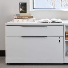 an open book on top of a white cabinet