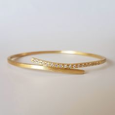 Handcrafted in 18 karat yellow gold and white diamonds, this bracelet is an elegant streak of gold, embracing your wrist. A wonderfully chic piece to add to any outfit, day or night. This feminine bracelet would make a very romantic gift. The thickness of the bracelet is 2X2 mm The inside diameter is 6 cm. If you need a different size, please contact me and let me know. :-: See more bracelets here: https://www.etsy.com/il-en/shop/OrnamentoStudio?ref=l2-shopheader-name&section_id=17248637 :-: Bangle Bracelets Gold Simple For Women, Gold Bracelet Simple, Diamond Bracelet Design, 18k Gold Bracelet, Jewelry Bracelets Gold, Gold Ring Designs, Diamond Bangles Bracelet, Bangles Jewelry Designs, Gold Jewelry Simple