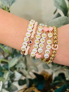 If you're looking to get your mini me or a little diva you know their own stack... look no further 💕 They'll be rockin' these adorable bracelets anywhere they go.  Extremely customizable to suit the style of your little princess.  Choose the color beads. Choose the letter style beads. Initial letter (accent bead) Colored heart /Evil eye. (accent bead) Names/wording  All gold beads are 14K Gold plated.  ALL BRACELETS WILL BE CHILD SIZE EITHER 5.5 INCHES OR 6 INCHES. (PLEASE SPECIFY) 👑 3 STACK Customized Trendy Pink Charm Bracelet, Gift Beaded Bracelets With Letter Beads, Trendy Stackable Charm Bracelet Gift, Trendy White Charm Bracelet For Mother's Day, Trendy White Charm Bracelet For Valentine's Day, Fun Pink Personalized Name Bracelet, Customizable Beaded Bracelets As Gift, Personalized Pink Name Bracelet, Personalized Pink Stackable Bracelets