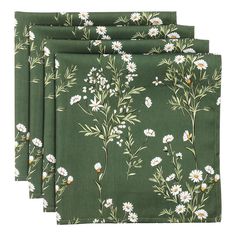 four green napkins with white flowers on them