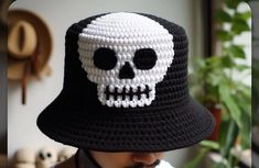 a man wearing a crocheted hat with a skull on it