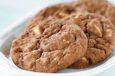 some cookies are in a white bowl on a table