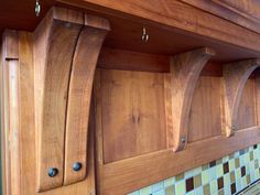 wooden kitchen cabinets with matching backsplashes and knobs on the upper part