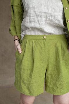 "Smart shorts being cut from lightweight, they work so well for balmy outside days. The shorts are designed to have a high-rise waist and pleats along the front that enhance the loose, breezy fit. Surely the garment is tailored with in-seam pockets that are an indispensable element of any practical apparel. The waistband is equipped with a shirr to better fit in shape. Such an up-to-date classic cut looks splendid with tops optionally covered with a jacket or you can create an astonishing combin Green Wide Leg Shorts With Pockets, Green Wide-leg Shorts With Pockets, Green Relaxed Fit Wide Leg Shorts, Green Bermuda Shorts With Relaxed Fit, Green Relaxed Fit Bermuda Shorts, Green High-waisted Relaxed Fit Shorts, Green Relaxed Fit High-waisted Shorts, Green Bermuda Bottoms With Elastic Waistband, Green Bermuda Shorts With Elastic Waistband