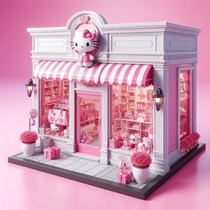 a hello kitty store with pink and white awnings on the front window, decorated in pink pom - poms