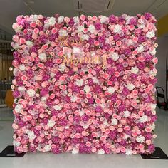 a pink and white flower wall with the words happy new year on it