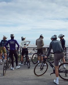 group of people on bicycles looking out over the city