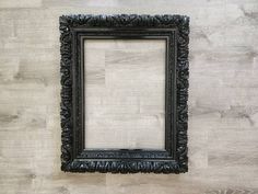 an old black frame hanging on the wall