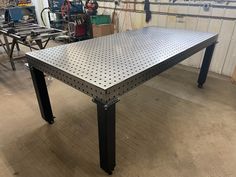 a metal table sitting inside of a garage